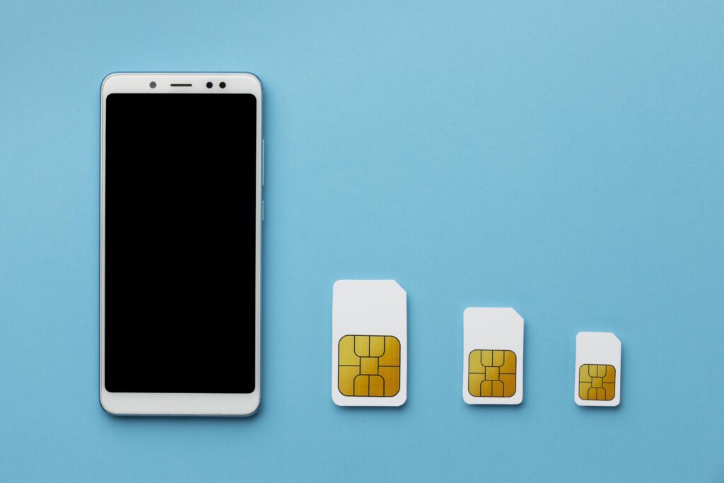 top-view-three-sim-cards-with-smartphone-copy-space