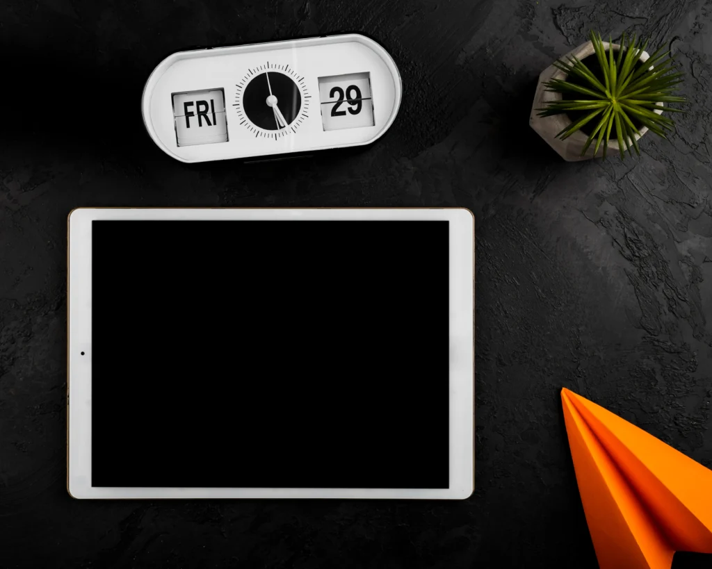 flat-lay-tablet-clock-paper-plane