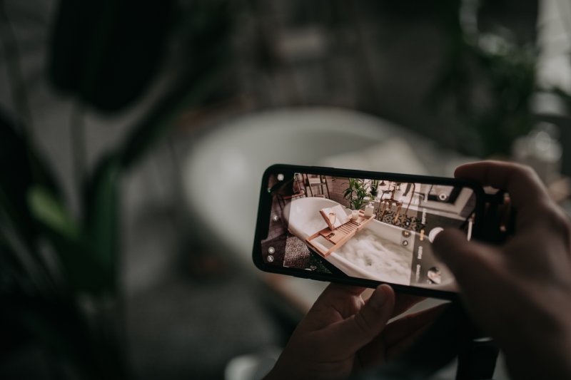 Luxurious interior bathroom in modern eco design taking videos from phone for Youtube social media
