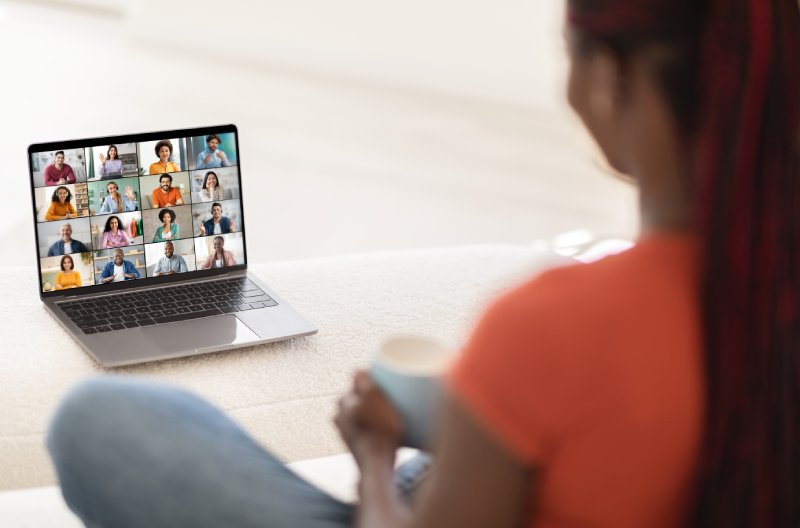 Woman Participating in Video Conference Meeting on Computer at Home