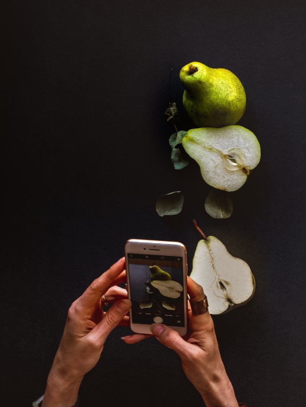 a-woman-taking-a-picture-of-food-2024-12-05-17-56-09-utc